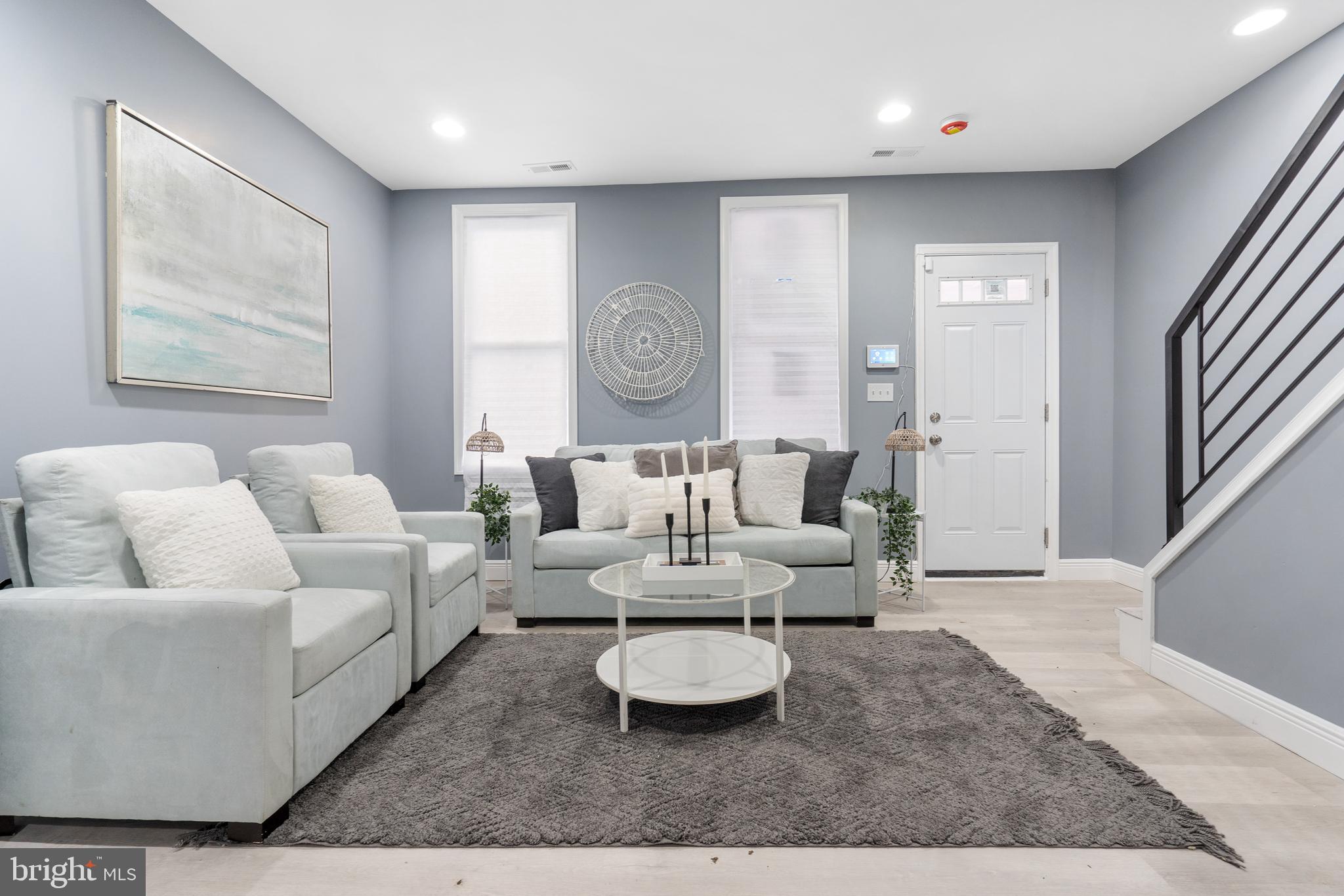 a living room with furniture and a large window