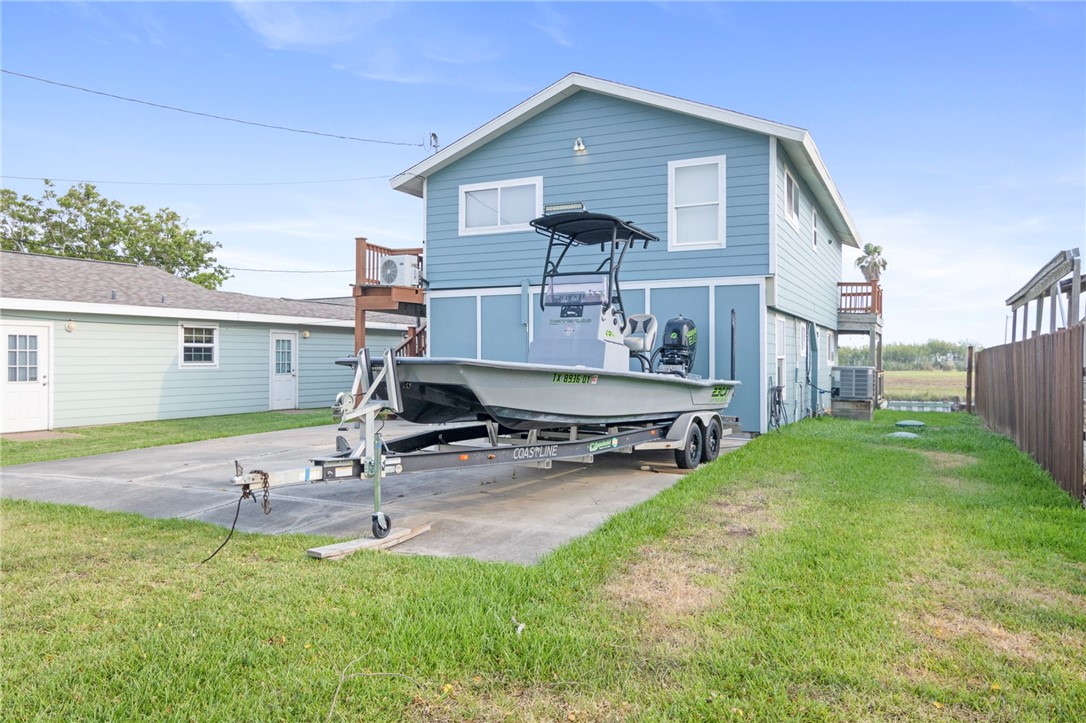 a view of backyard of house with wooden deck and seating