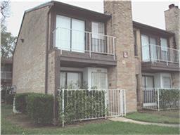 a view of a brick house with many windows