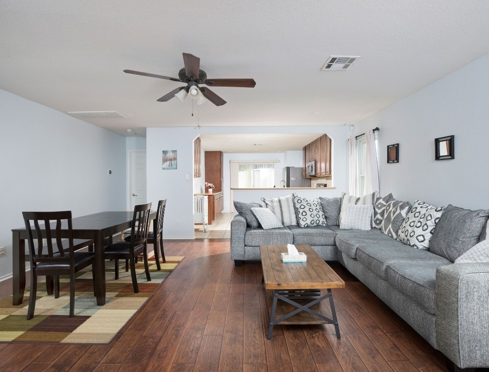 a living room with furniture wooden floor and a window