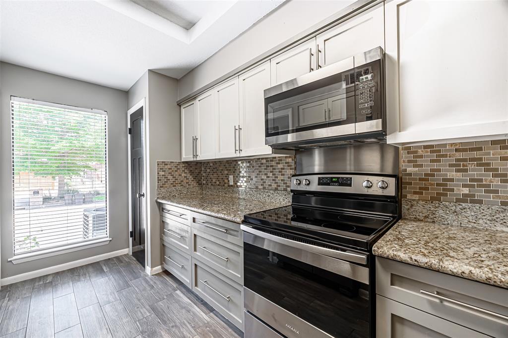 a kitchen with a stove and a microwave