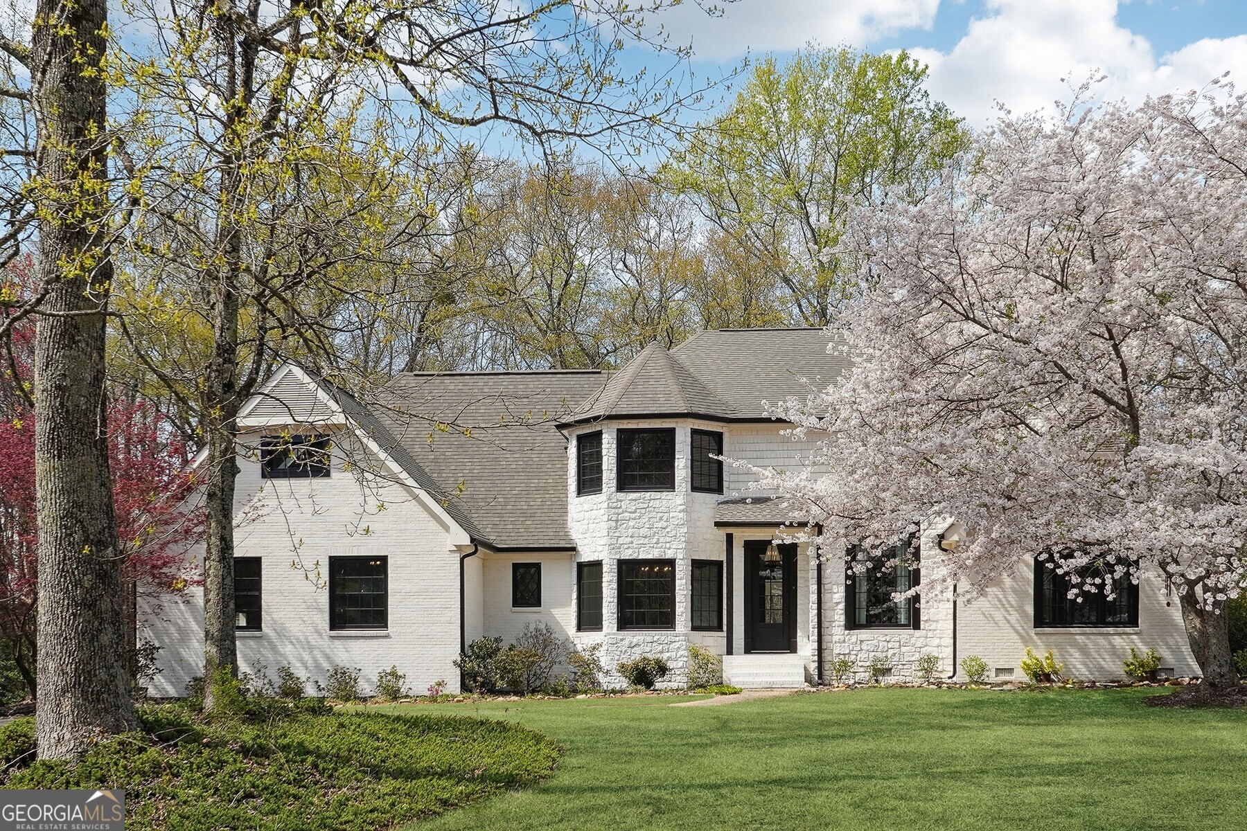 a front view of a house with a garden