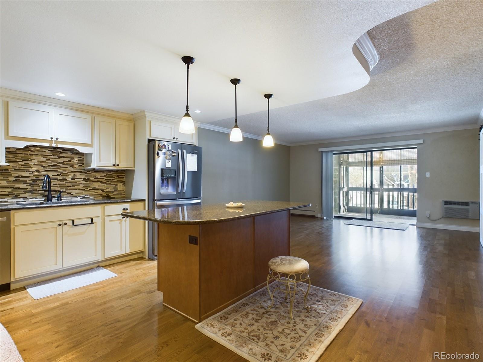 a kitchen with granite countertop wooden cabinets and white appliances