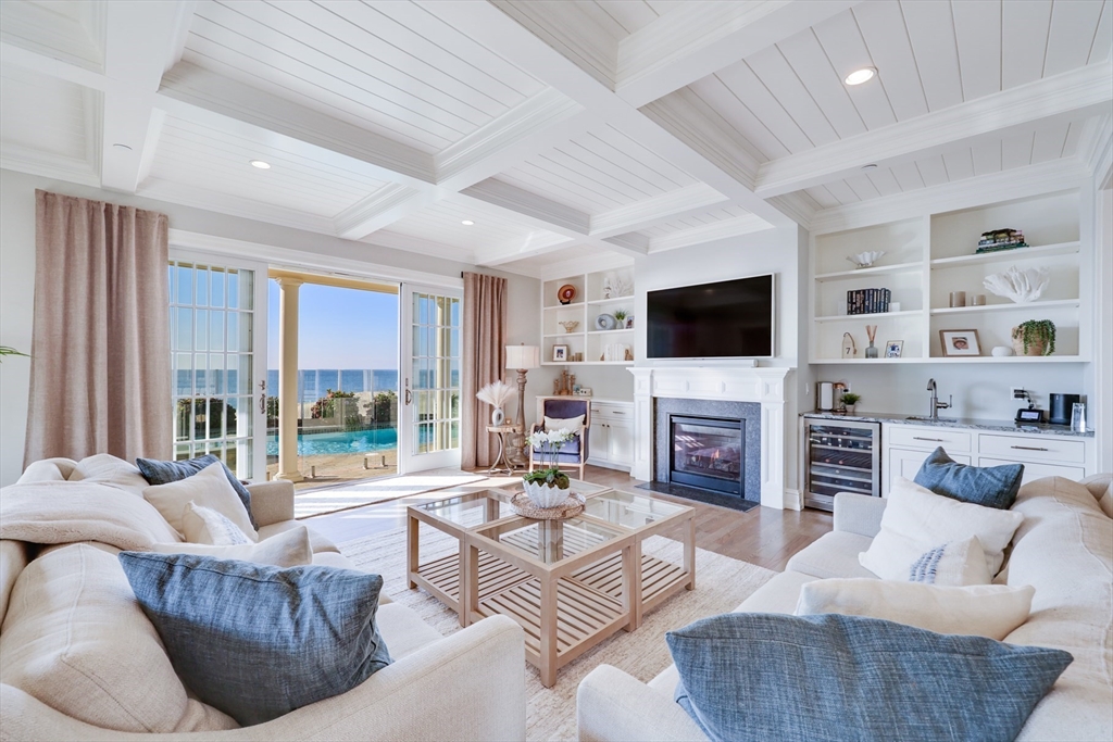 a living room with fireplace furniture and a flat screen tv