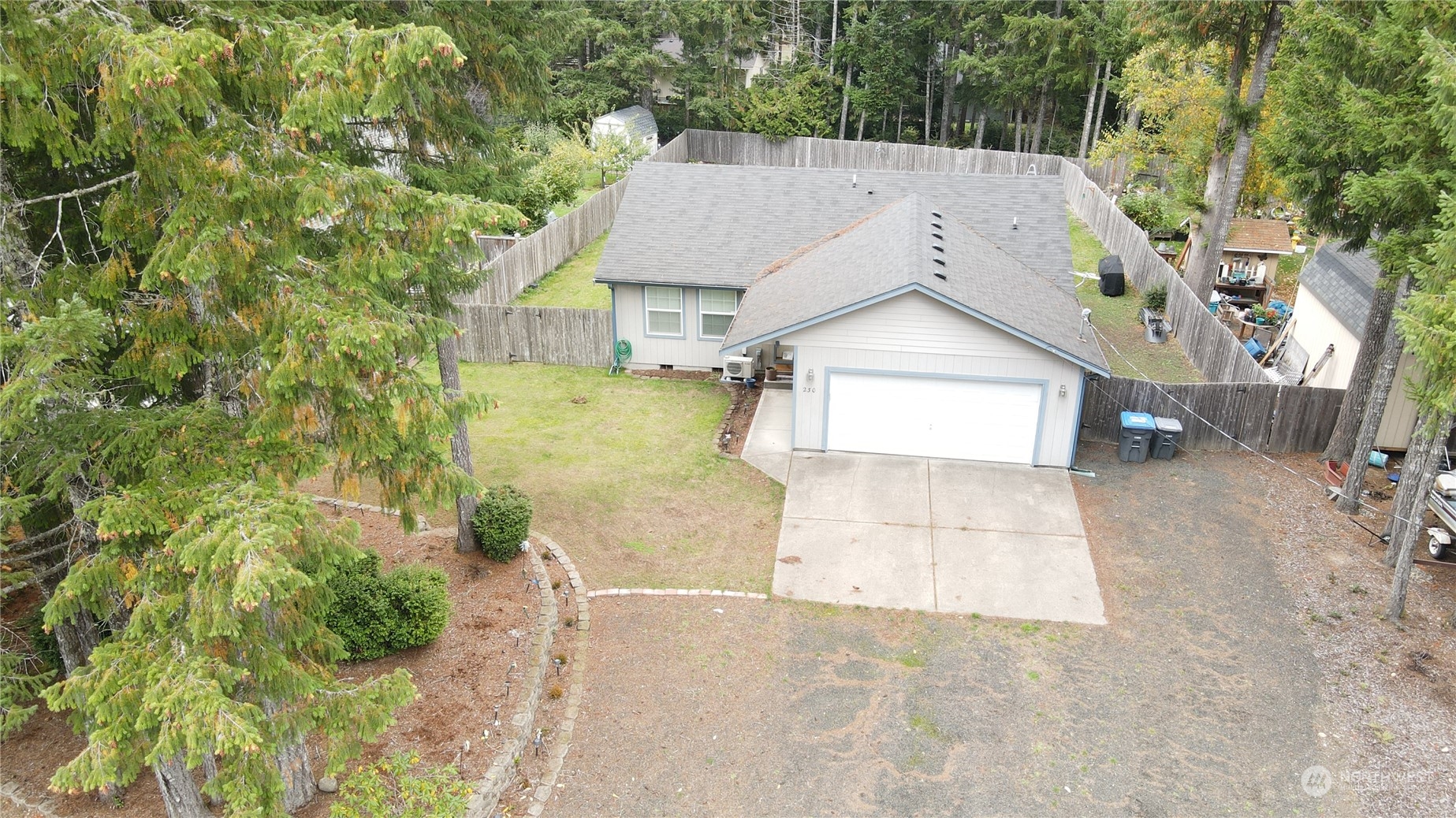 a view of a house with a yard and large tree