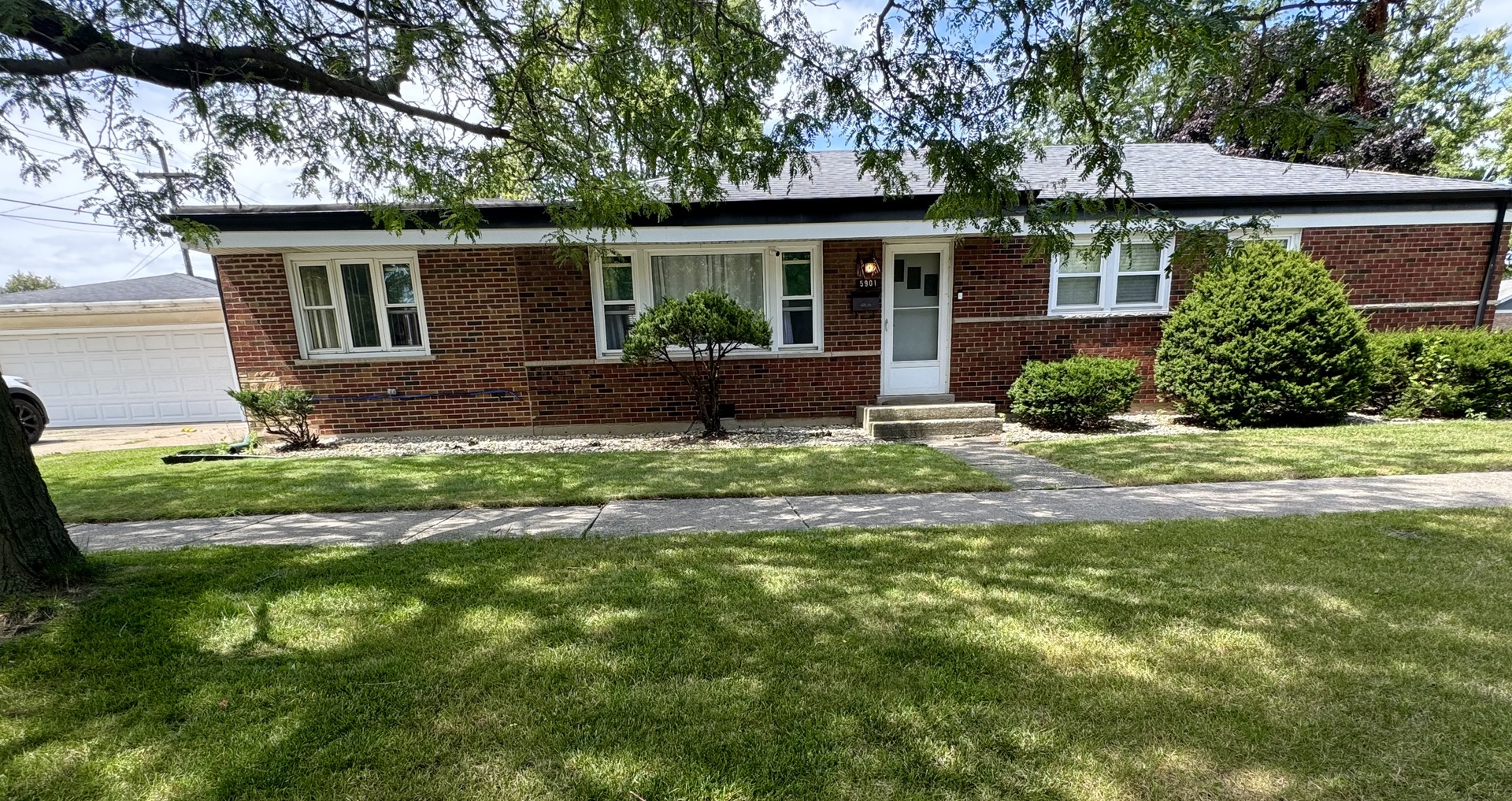 a view of a house with a yard and a garden