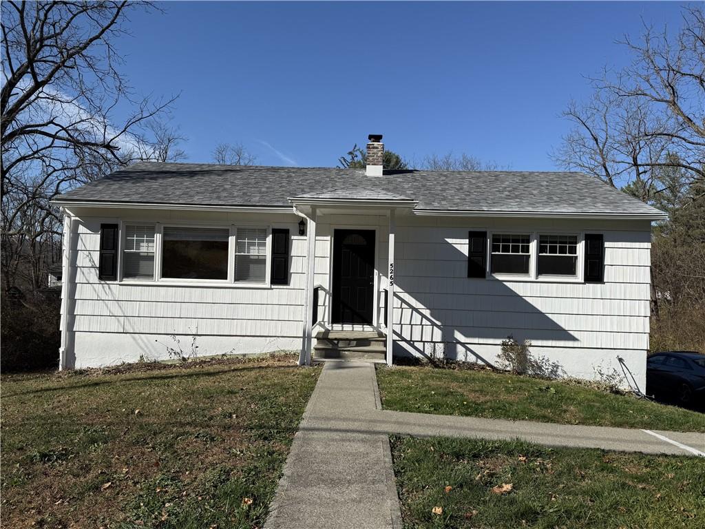 a front view of a house with yard