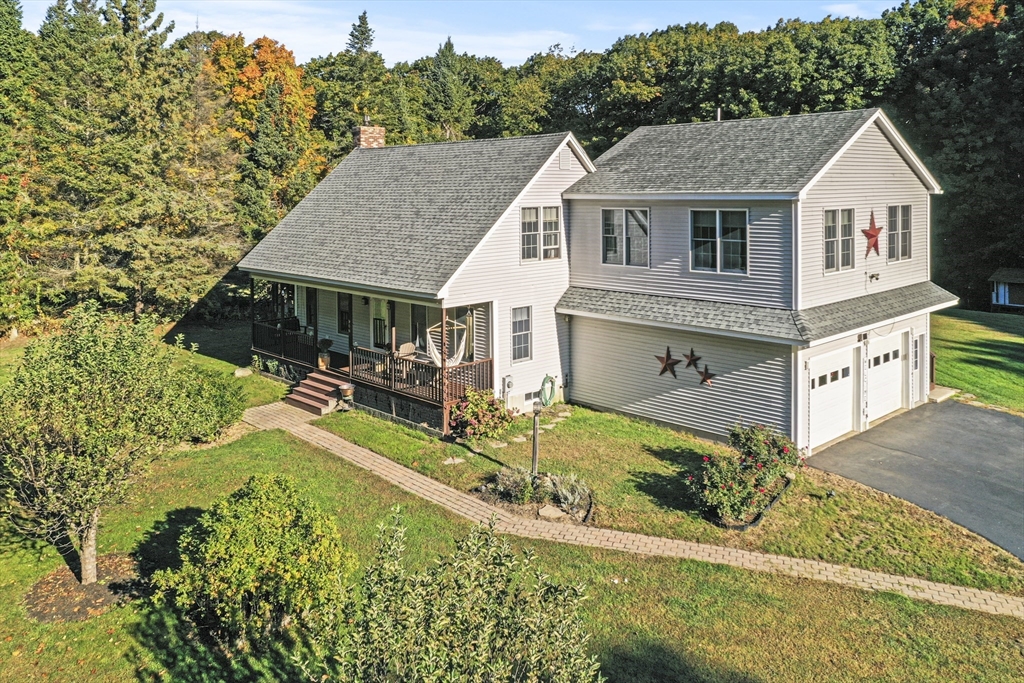 an aerial view of a house with a yard table and chairs