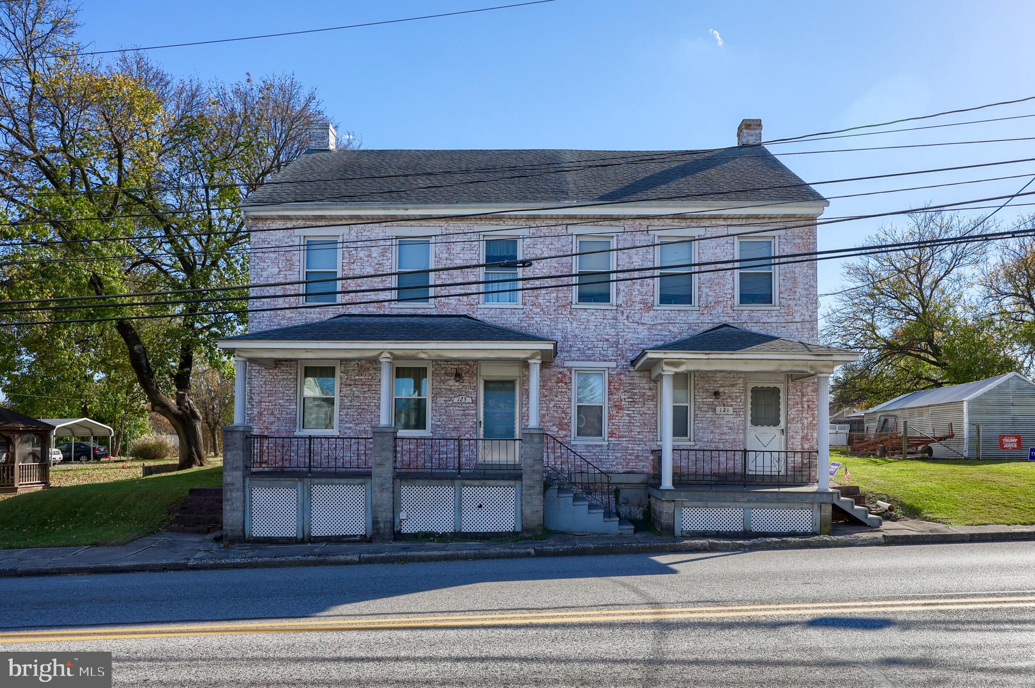 a front view of a house with a garden