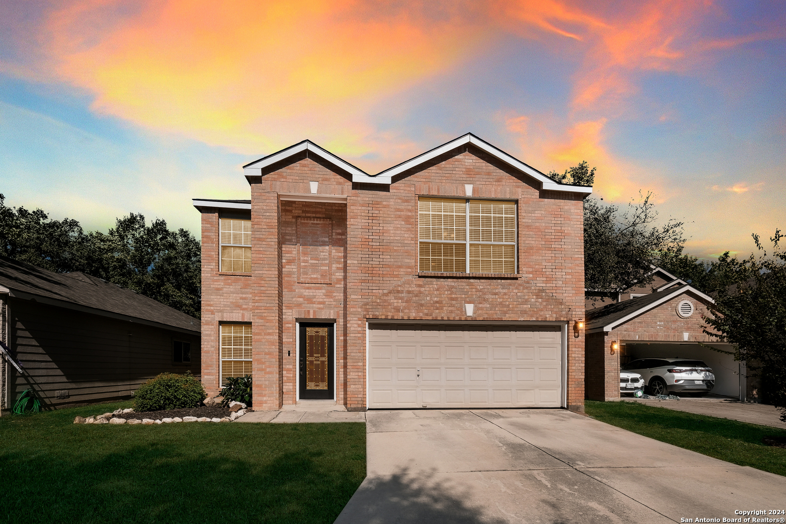 a front view of a house with a yard and garage