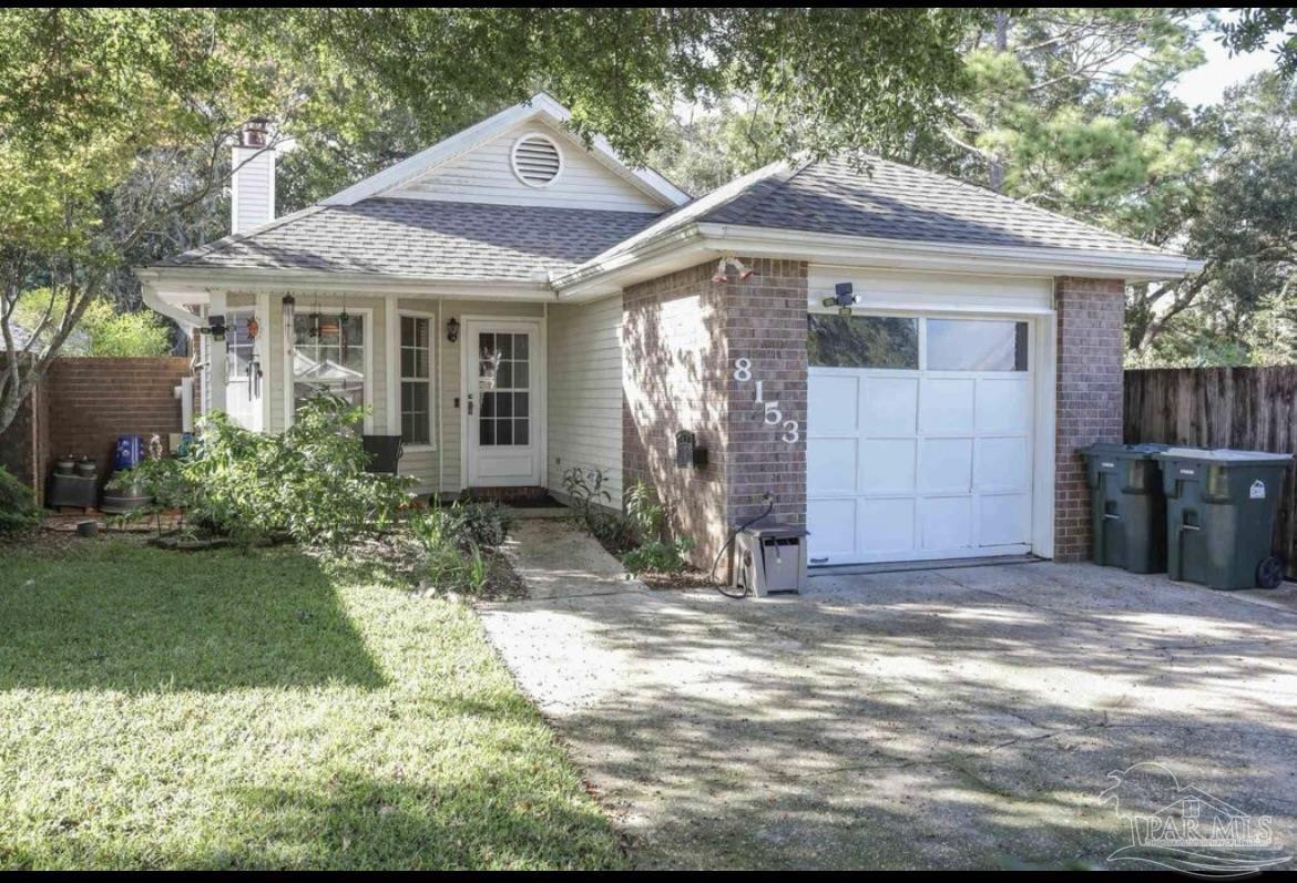 a front view of a house with a garden