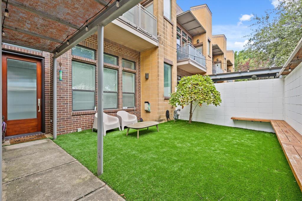 a view of a chair and table in backyard of the house