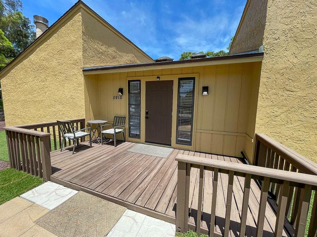 a view of a house with wooden deck