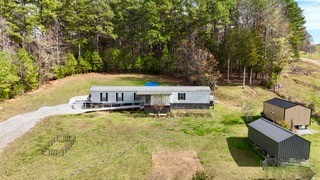 an aerial view of a house with yard swimming pool and outdoor seating