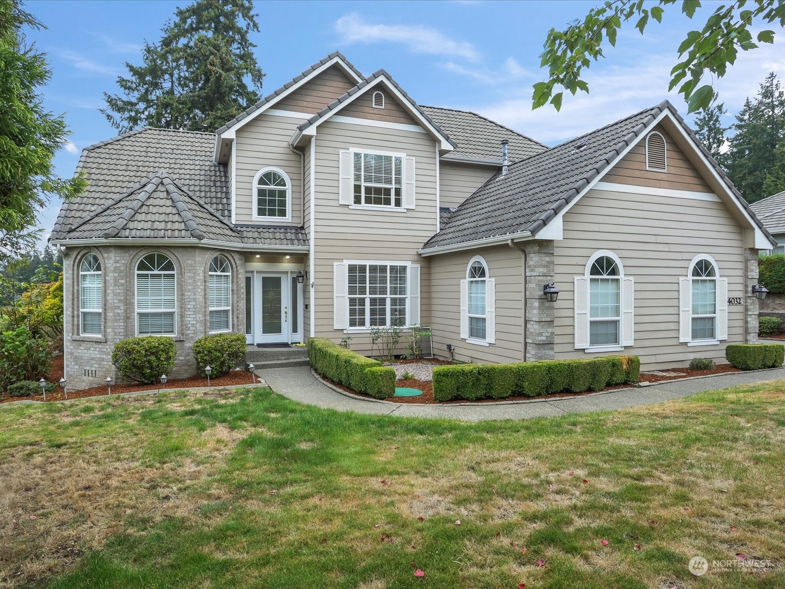 a front view of a house with a yard