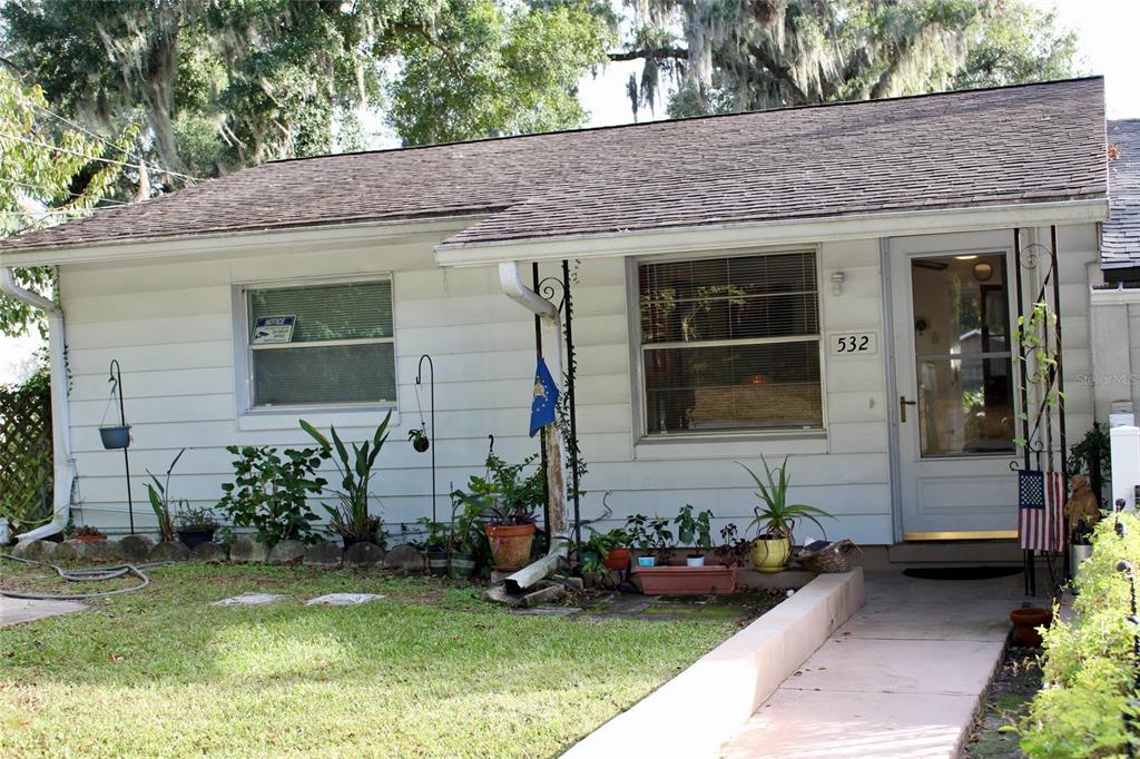 a front view of a house with garden