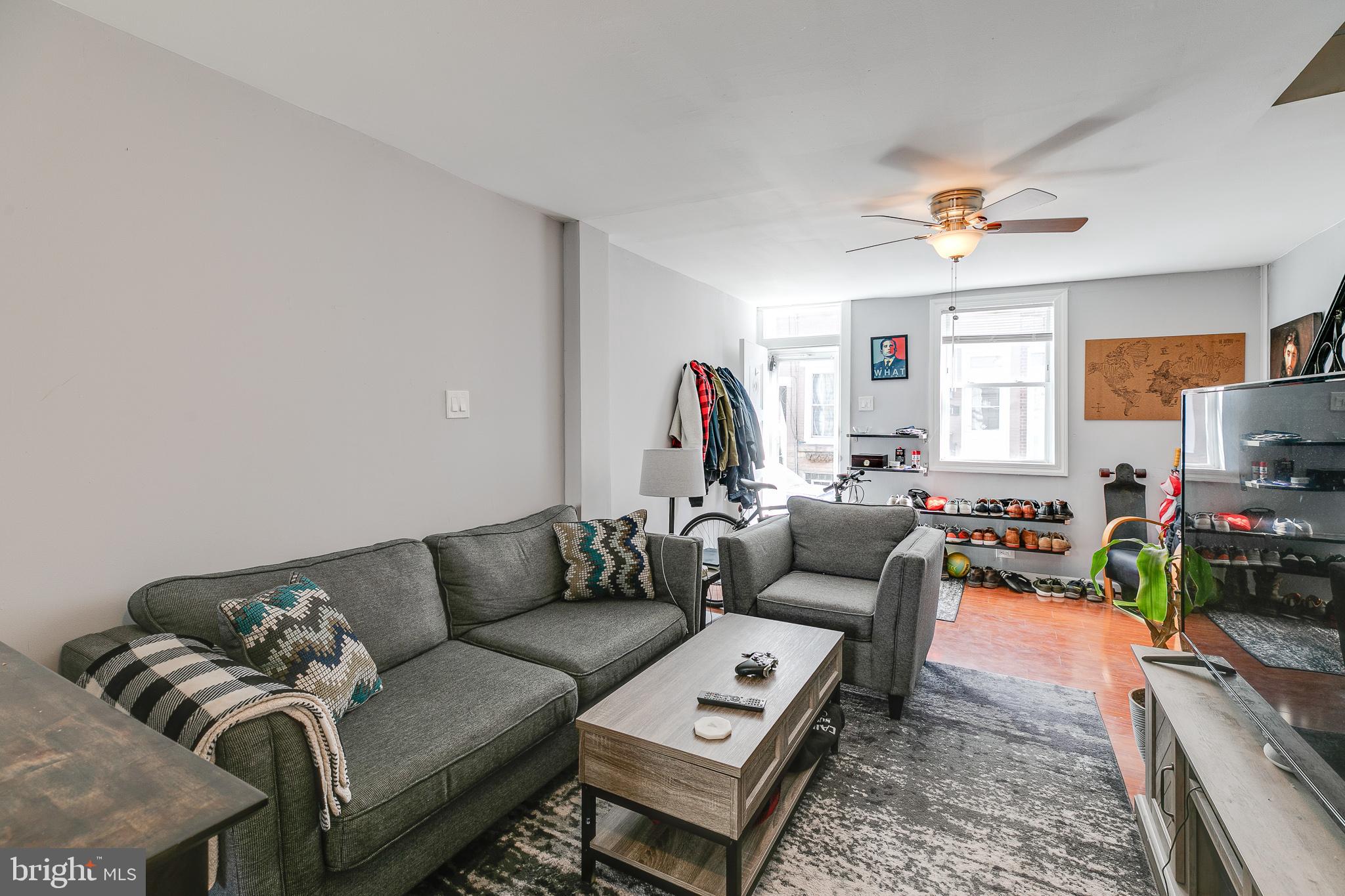 a living room with furniture a fireplace and a flat screen tv