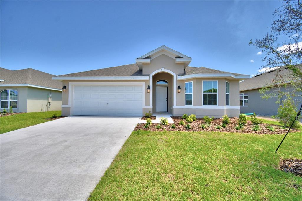 a front view of a house with a yard