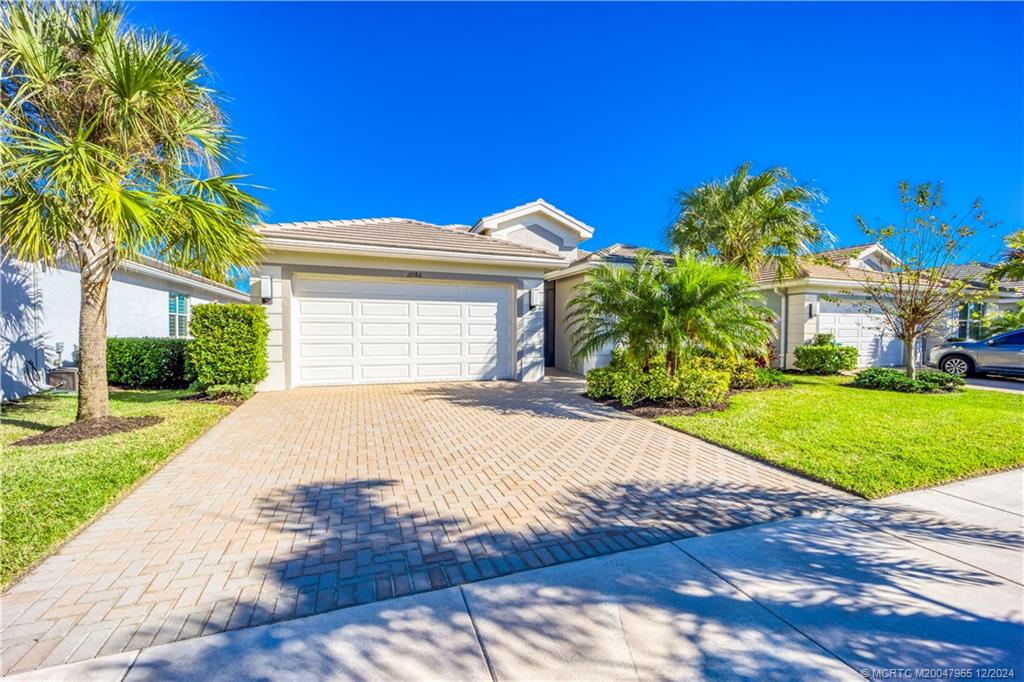 a front view of a house with a yard and garage