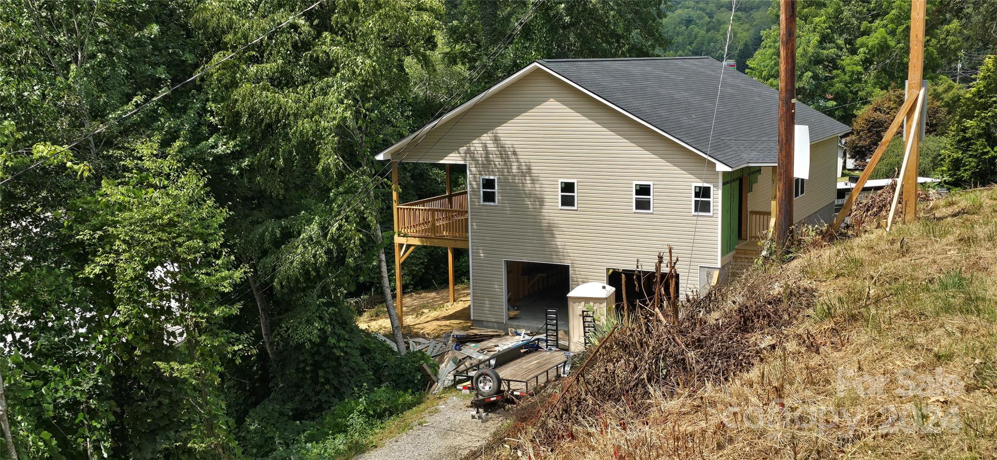 a view of house with a yard and sitting area