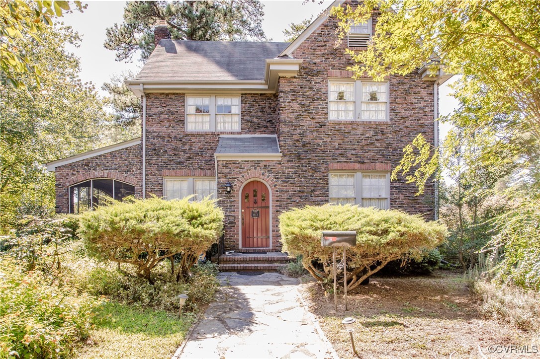 a front view of a house with garden