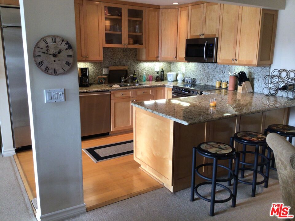 a kitchen with granite countertop a sink and a stove top oven