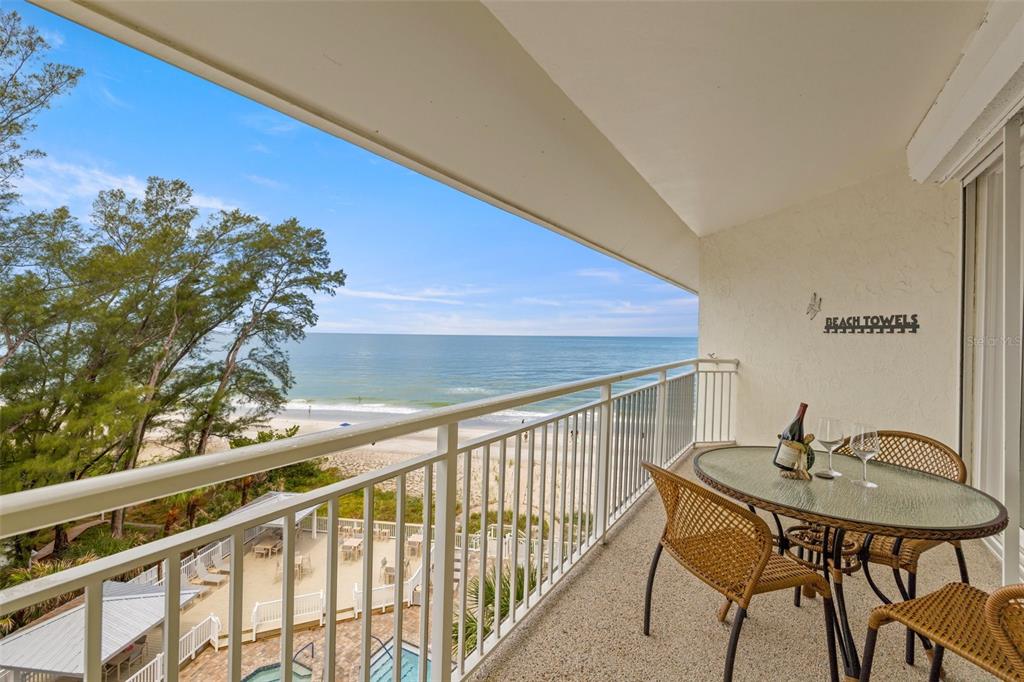 a view of a balcony with a table and chairs