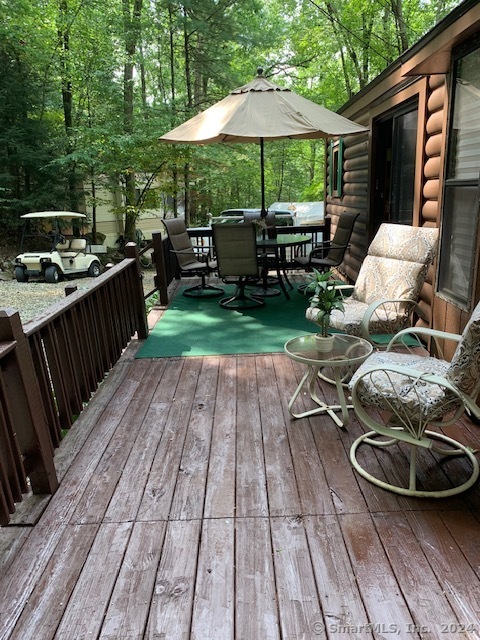 a view of backyard with seating space and wooden floor