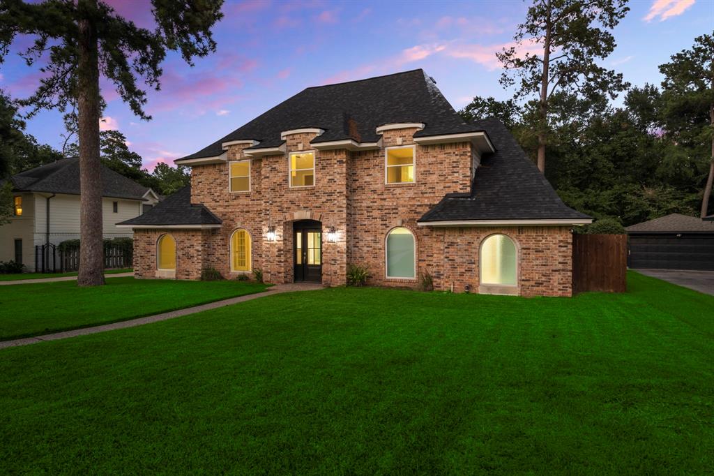 a front view of a house with a garden