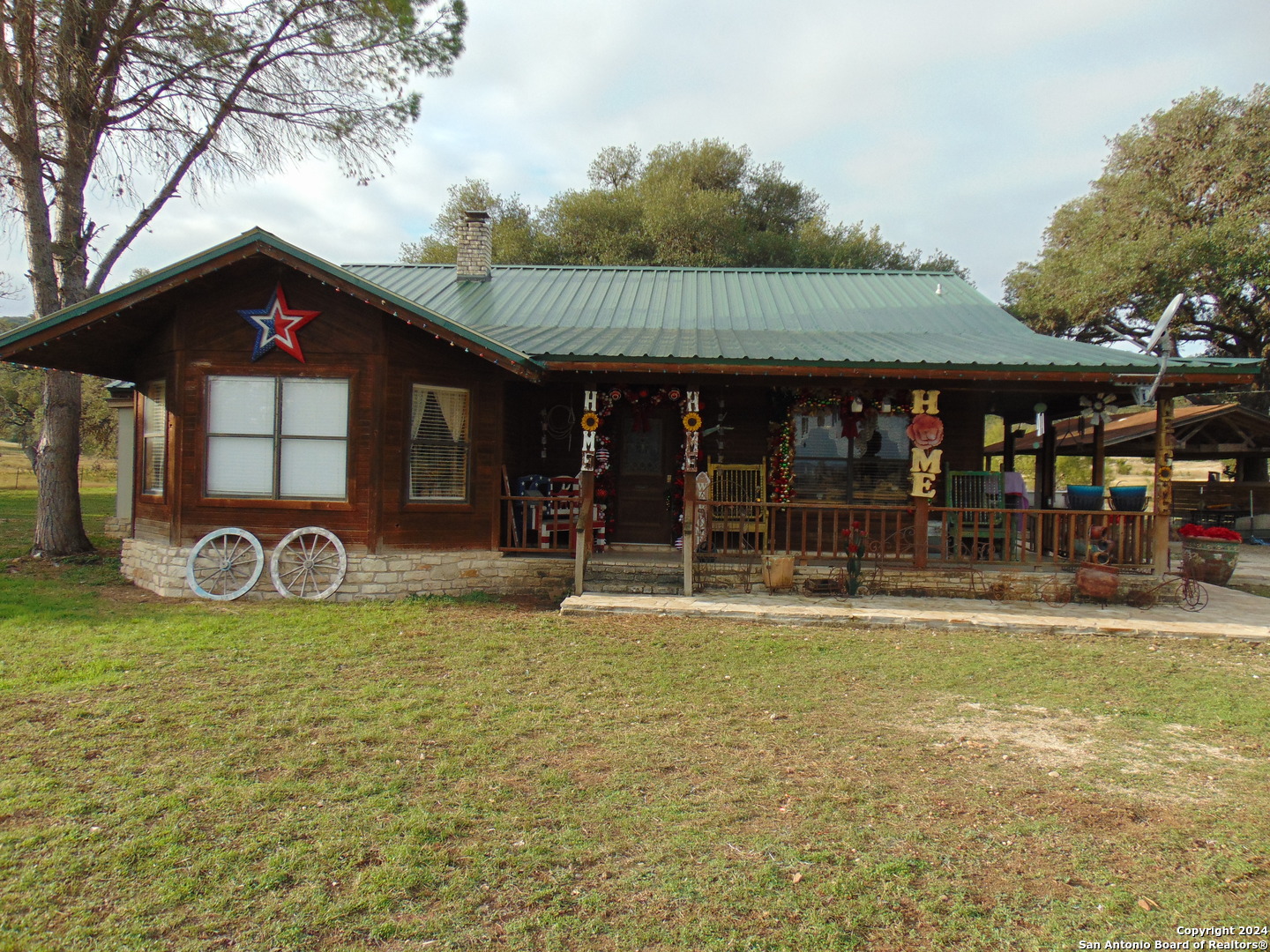 a view of a house with backyard porch and sitting area