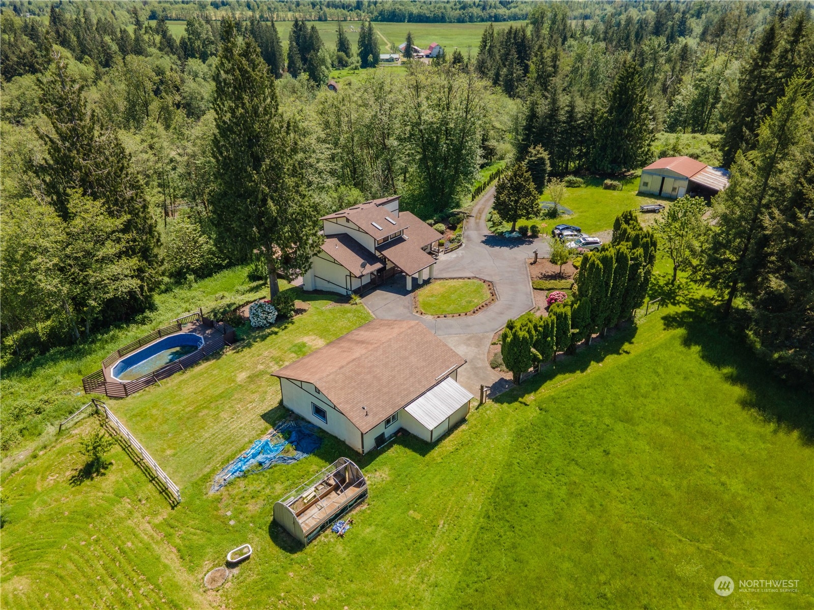 an aerial view of a house with a swimming pool