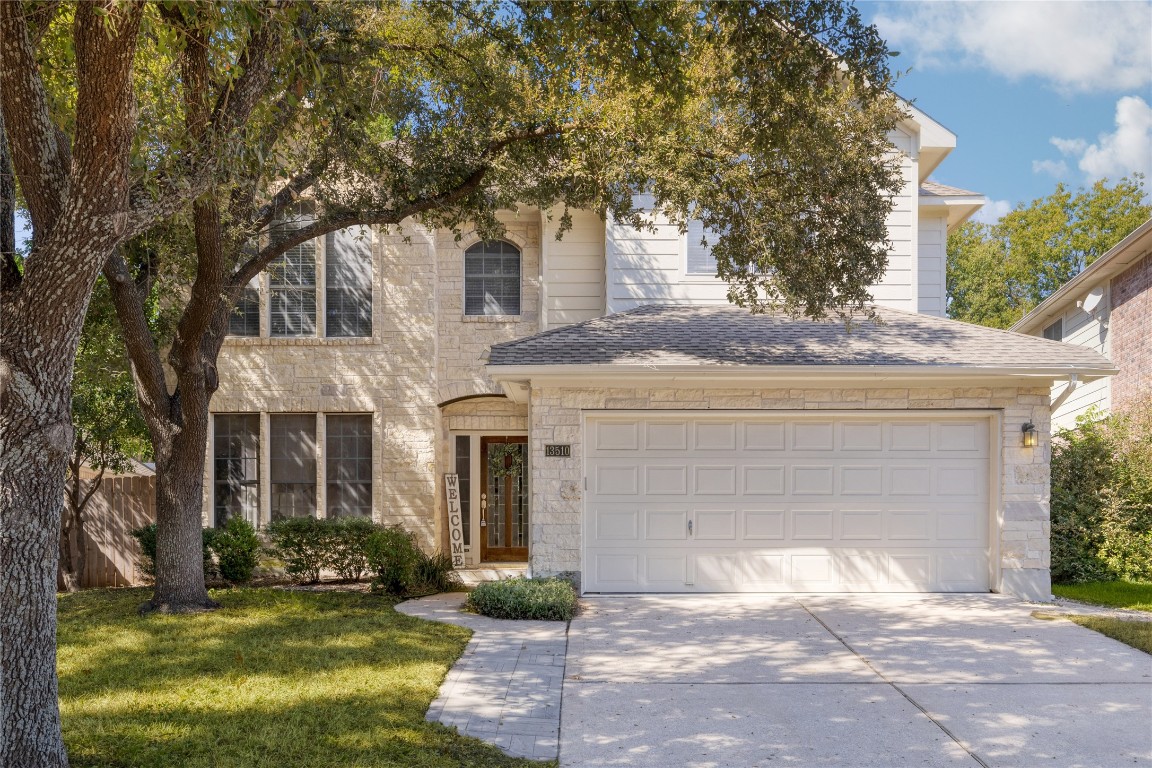 a front view of a house with a yard and garage