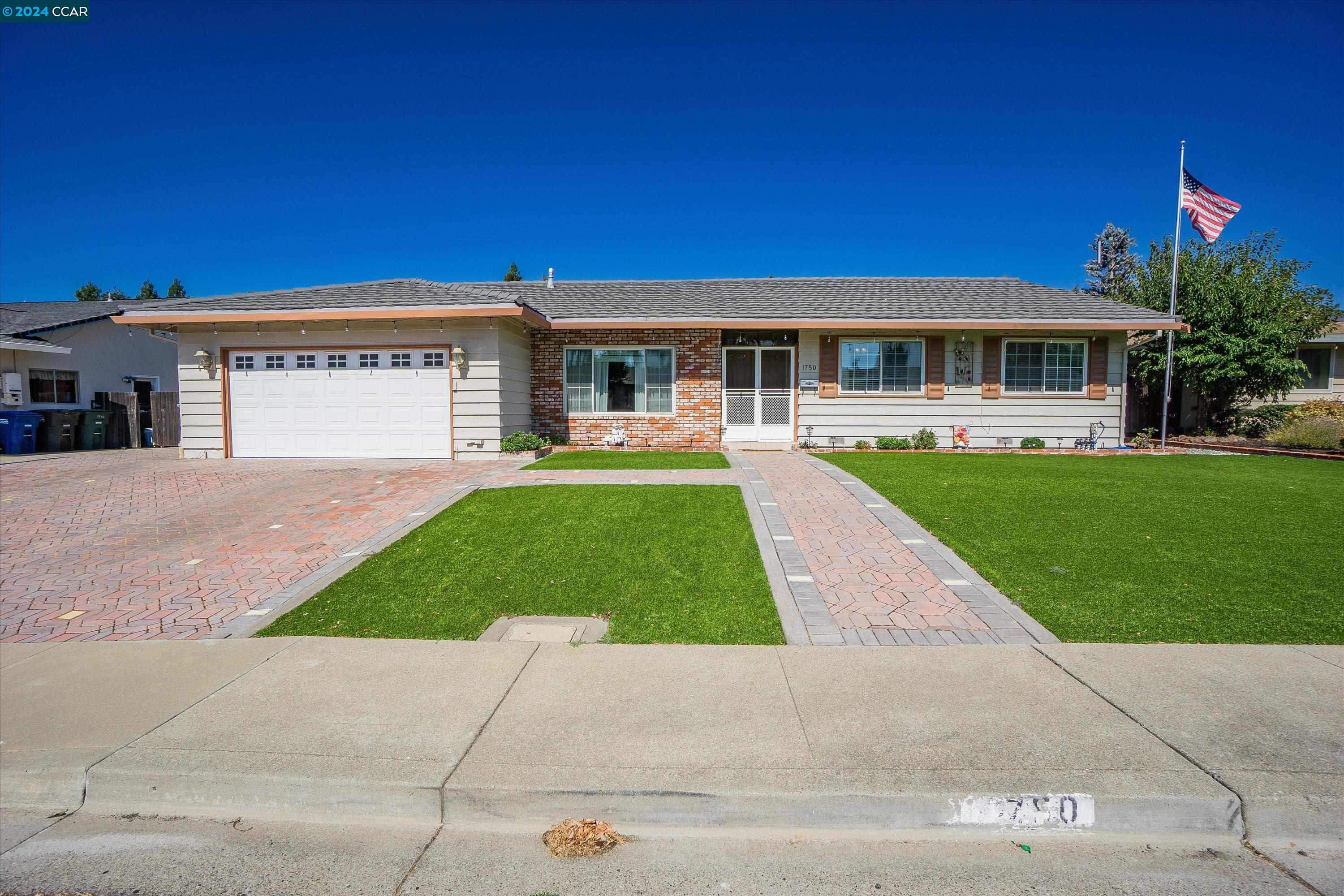 a front view of house with yard and green space