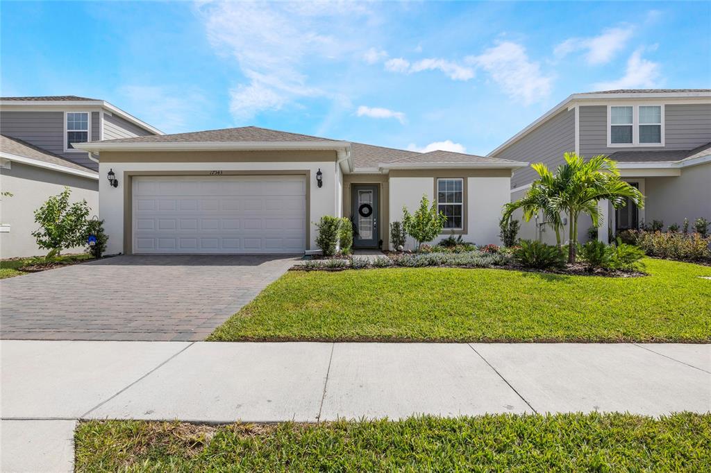 a front view of a house with a yard and garage