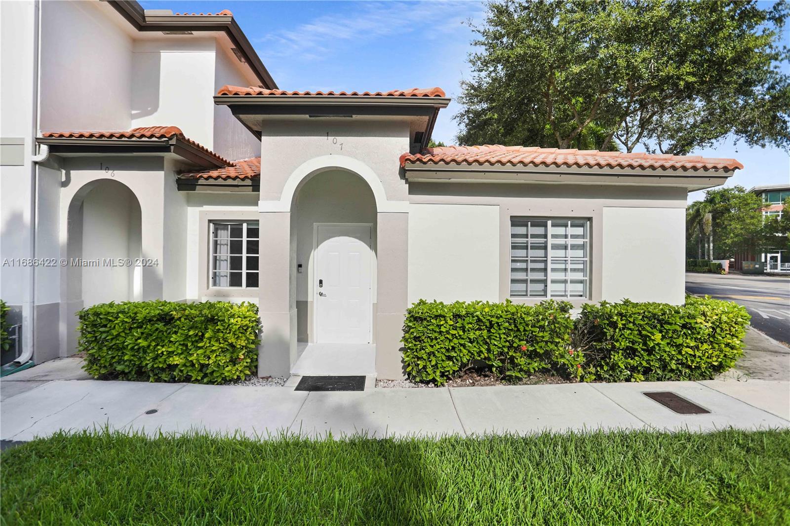 a front view of a house with garden