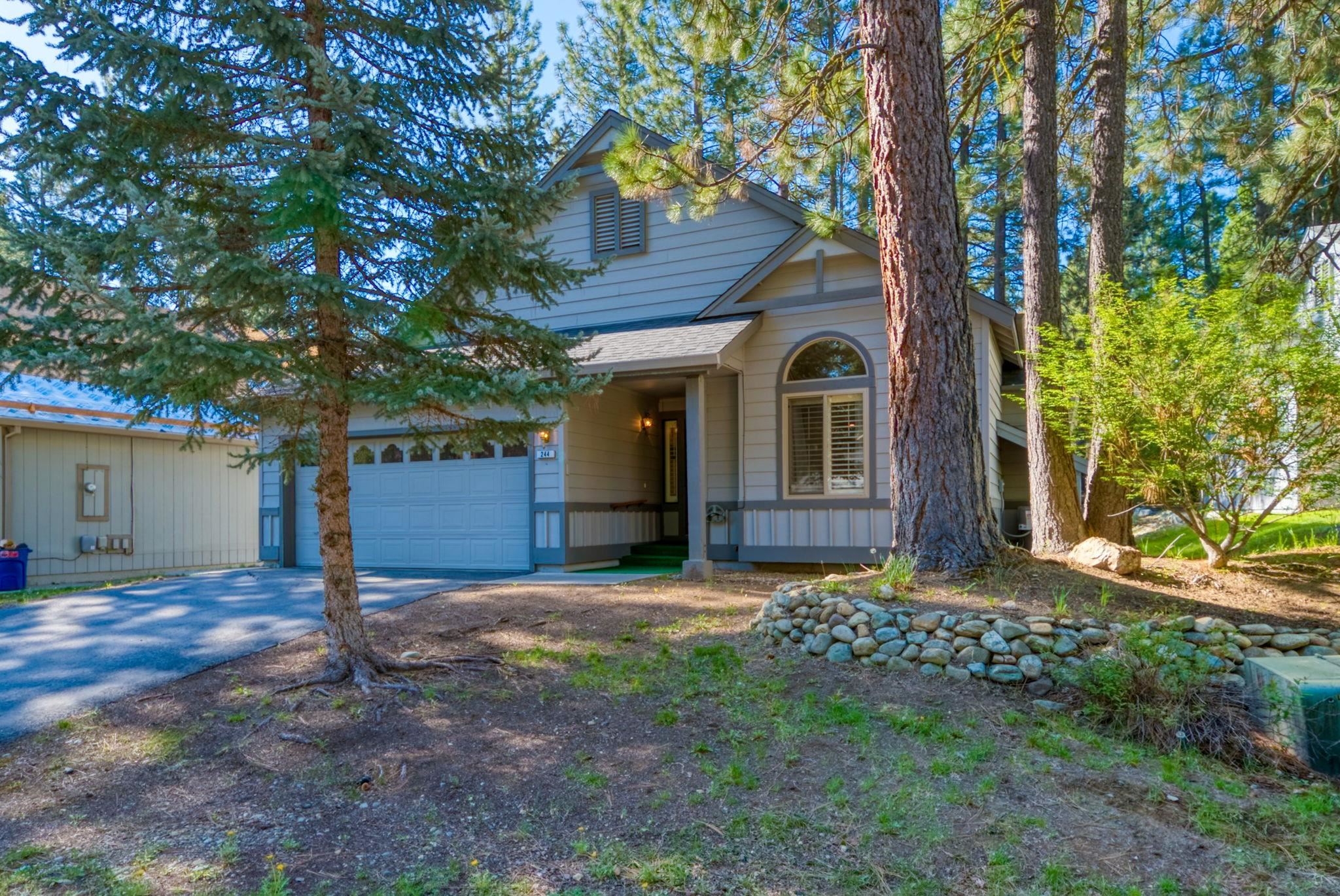 a view of a house with a tree in front of it