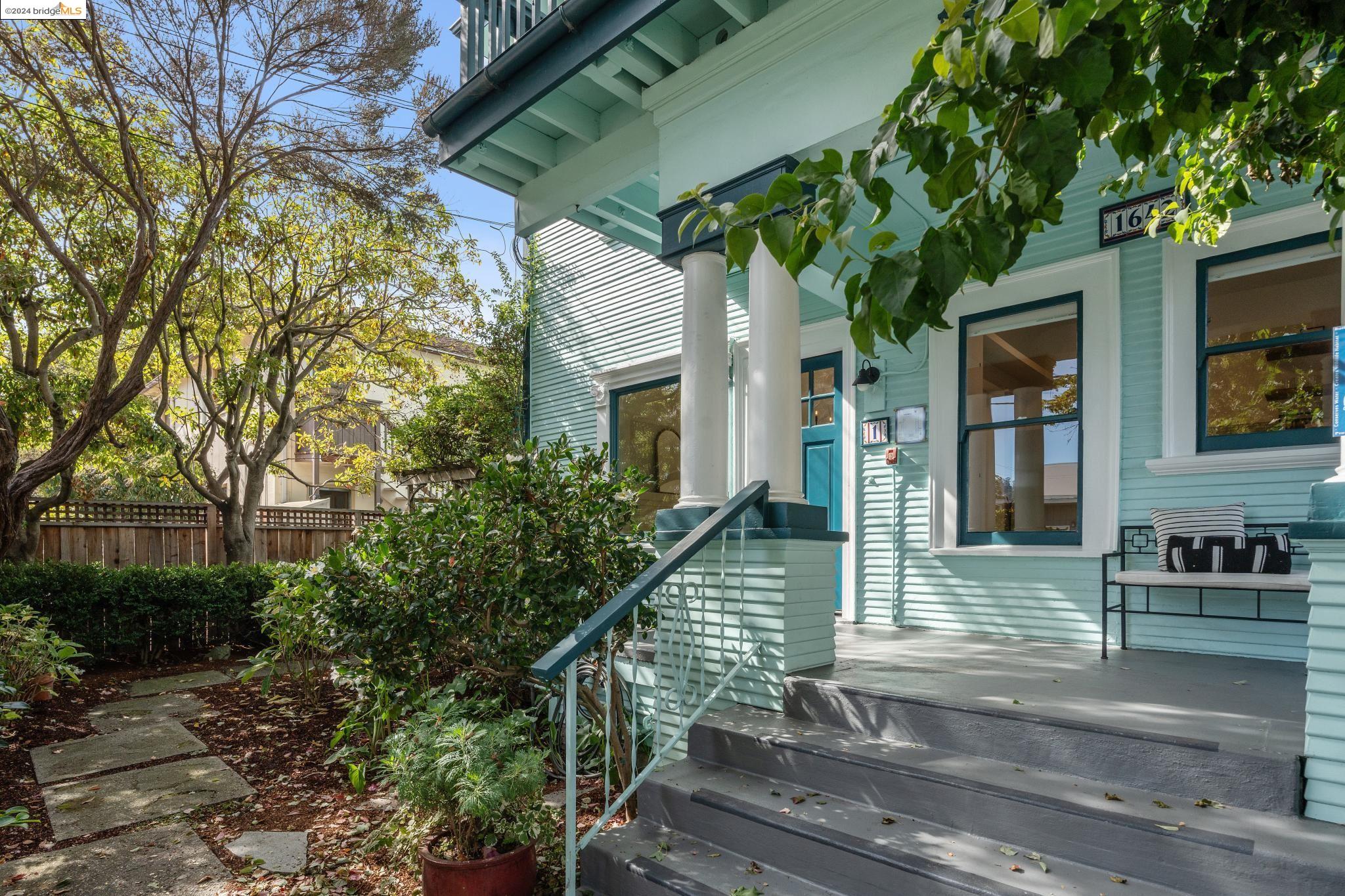 a front view of a house with plants