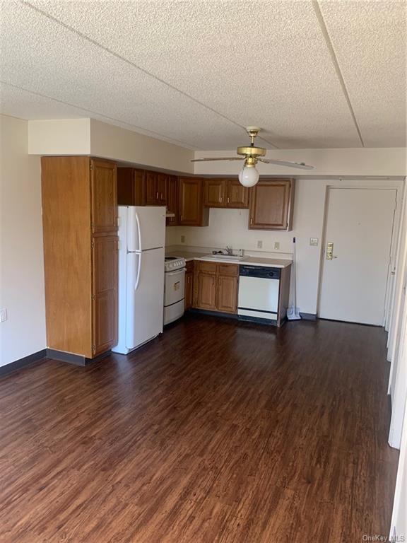 a kitchen with a wooden floor and steel appliances