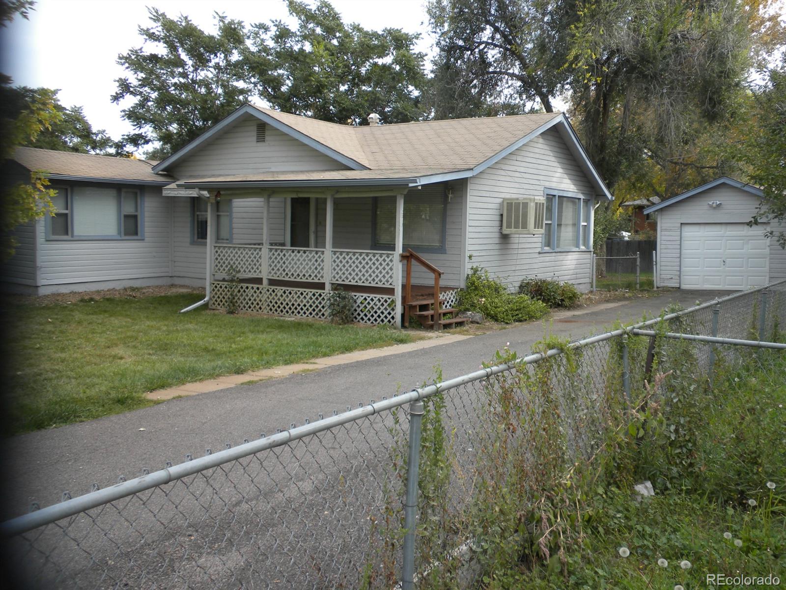 a view of a house with a yard and sitting area