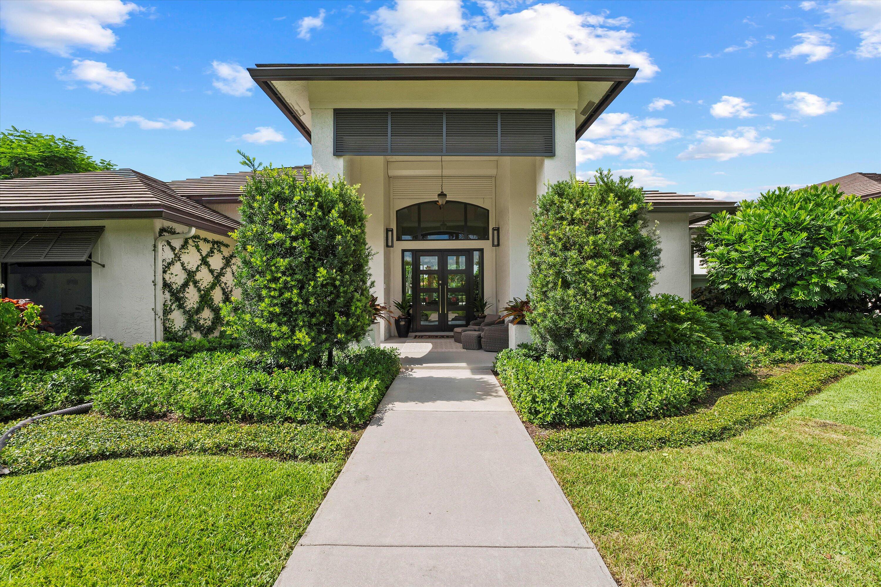 a front view of a house with garden