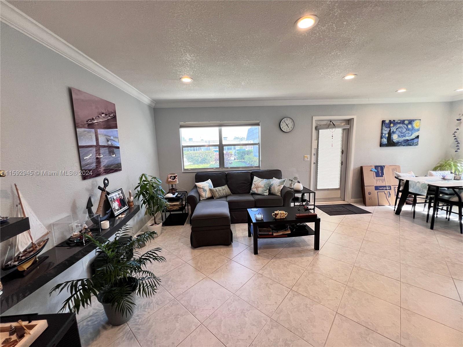 a living room with furniture gym equipment and a window