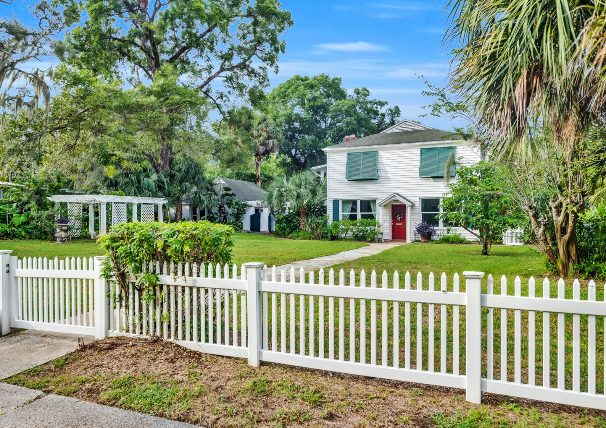 a front view of a house with a garden