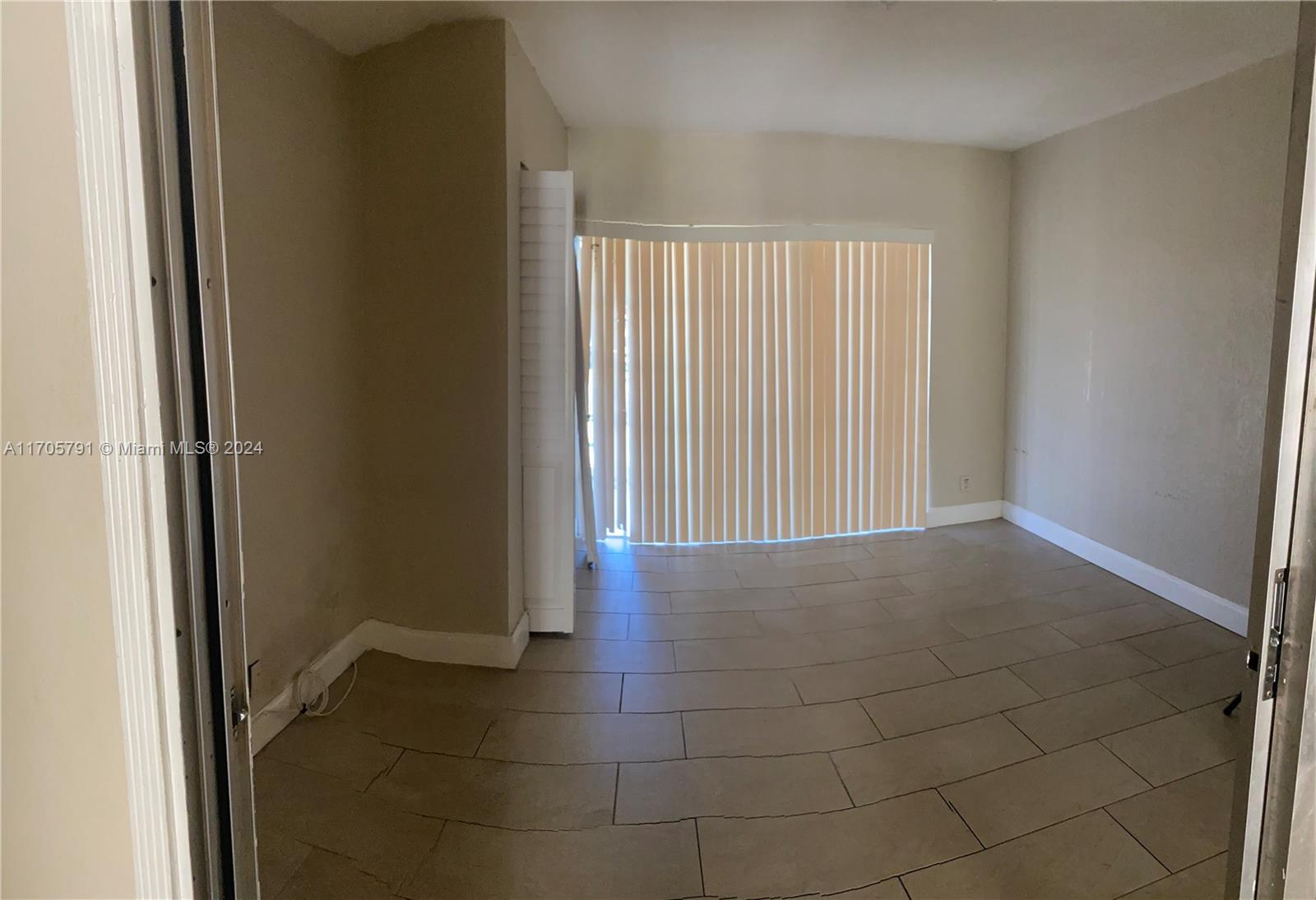 a view of livingroom with an empty space and window