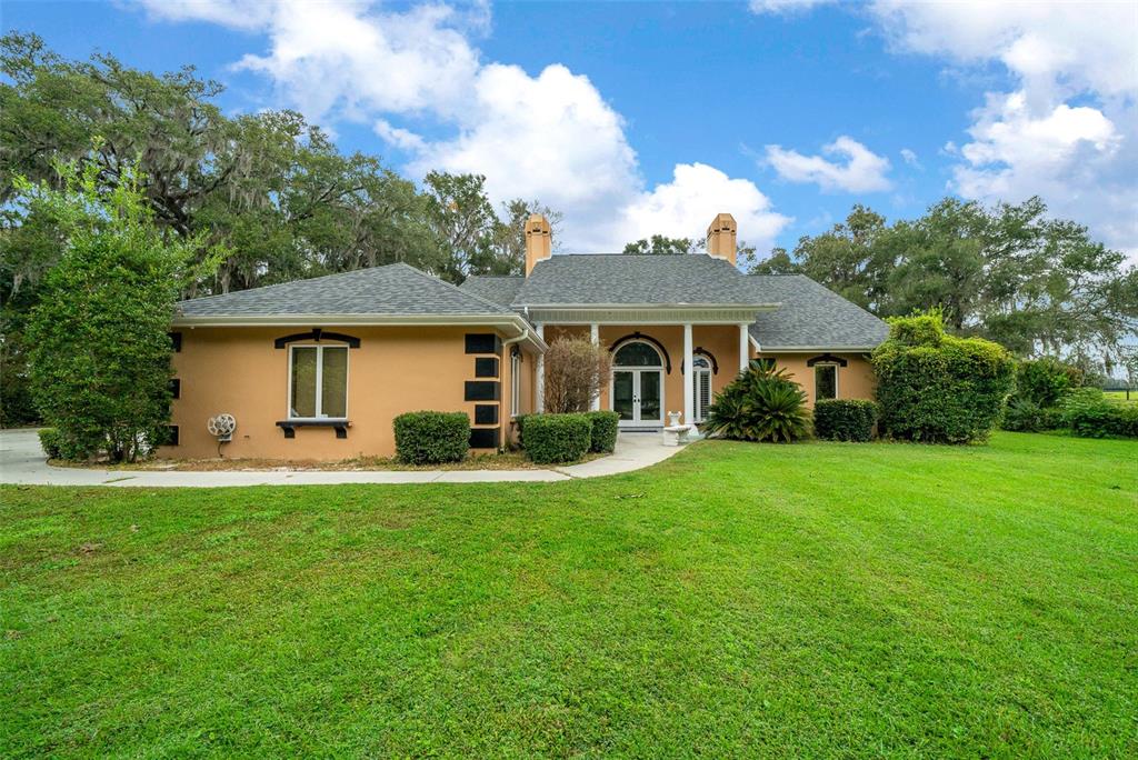 a front view of a house with a garden