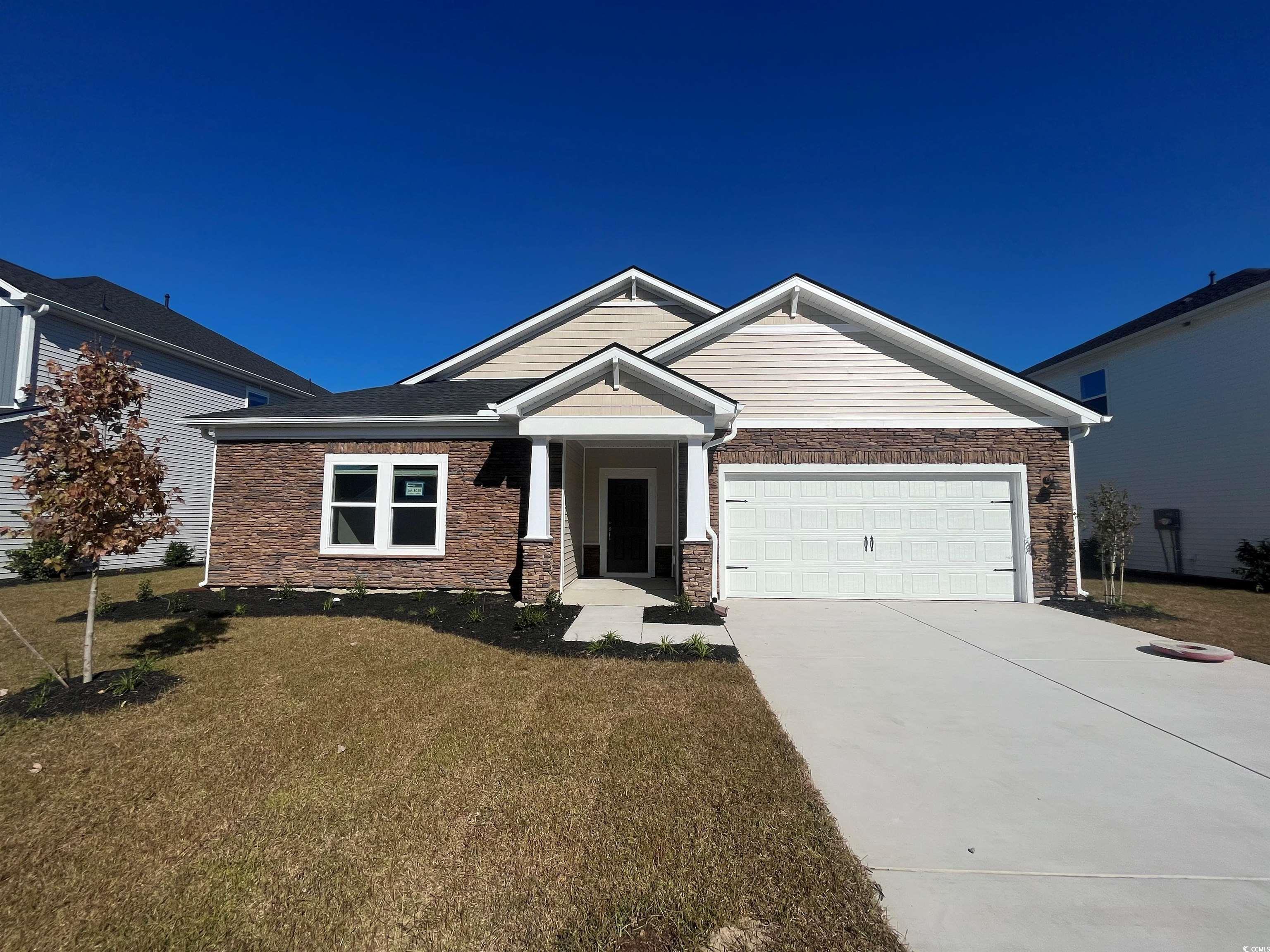 Craftsman-style house featuring a front lawn and a