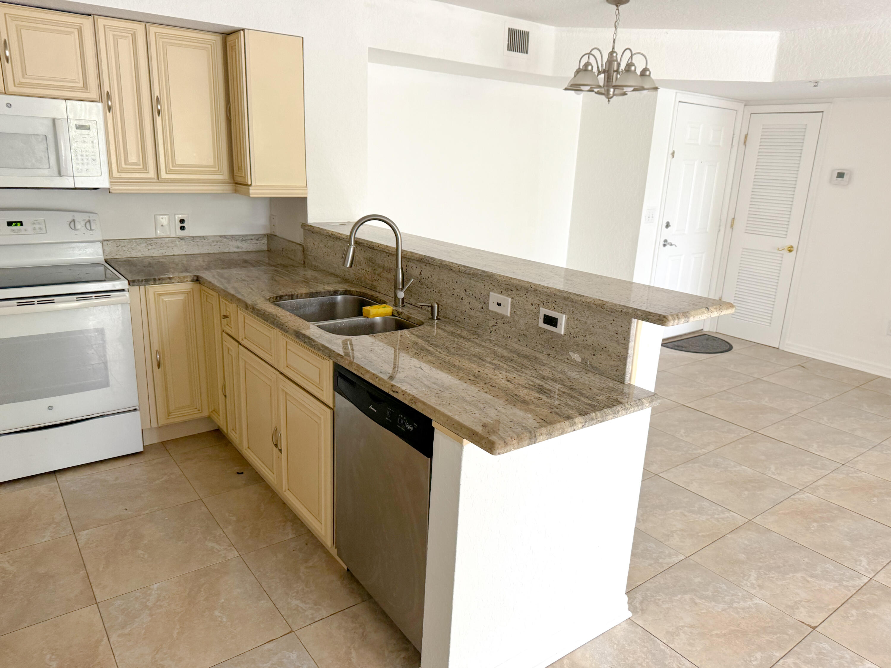 a kitchen with a sink stove and cabinets