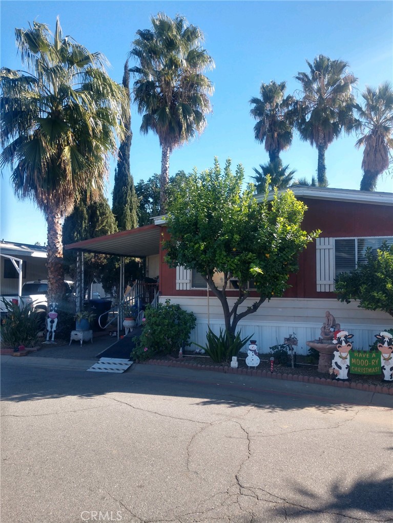 a front view of a house with a garden and a yard