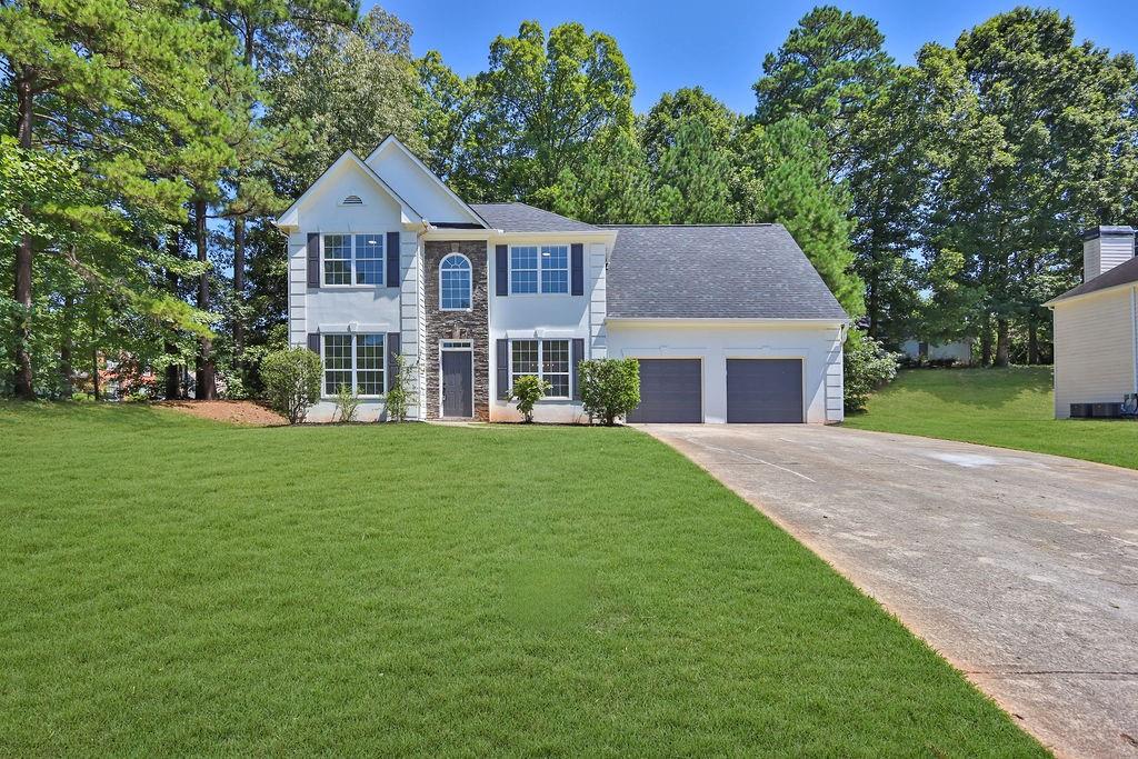 a front view of a house with garden