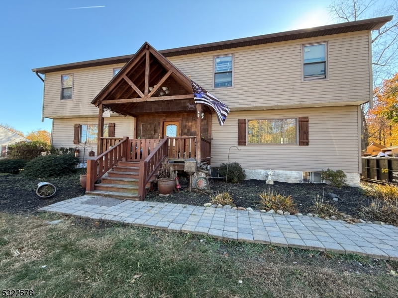 a view of a house with backyard and sitting area