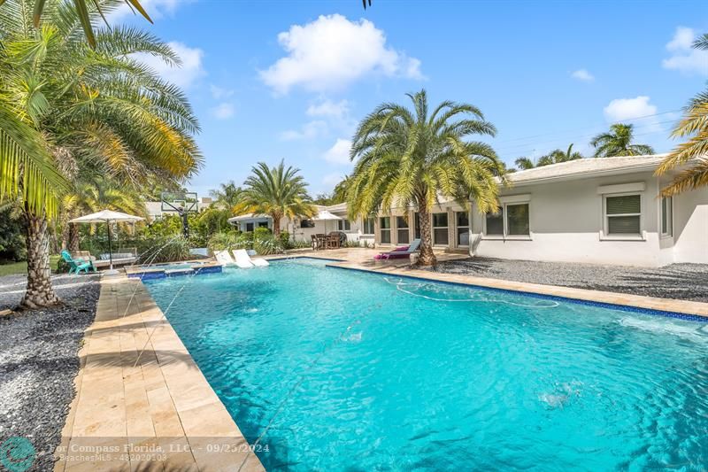 a view of swimming pool with sitting area